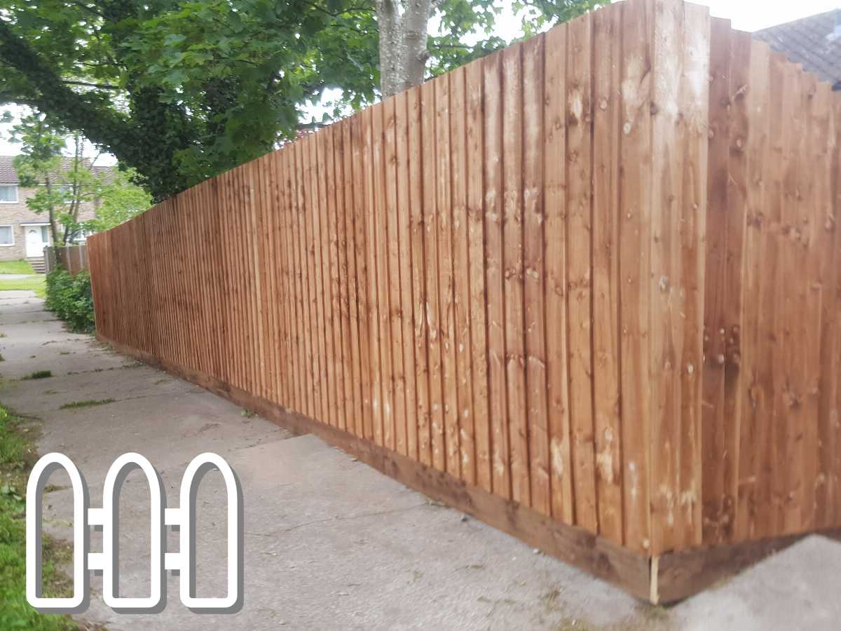 Long wooden fence along a sidewalk in a residential area, showcasing fresh wood planks and sturdy construction.