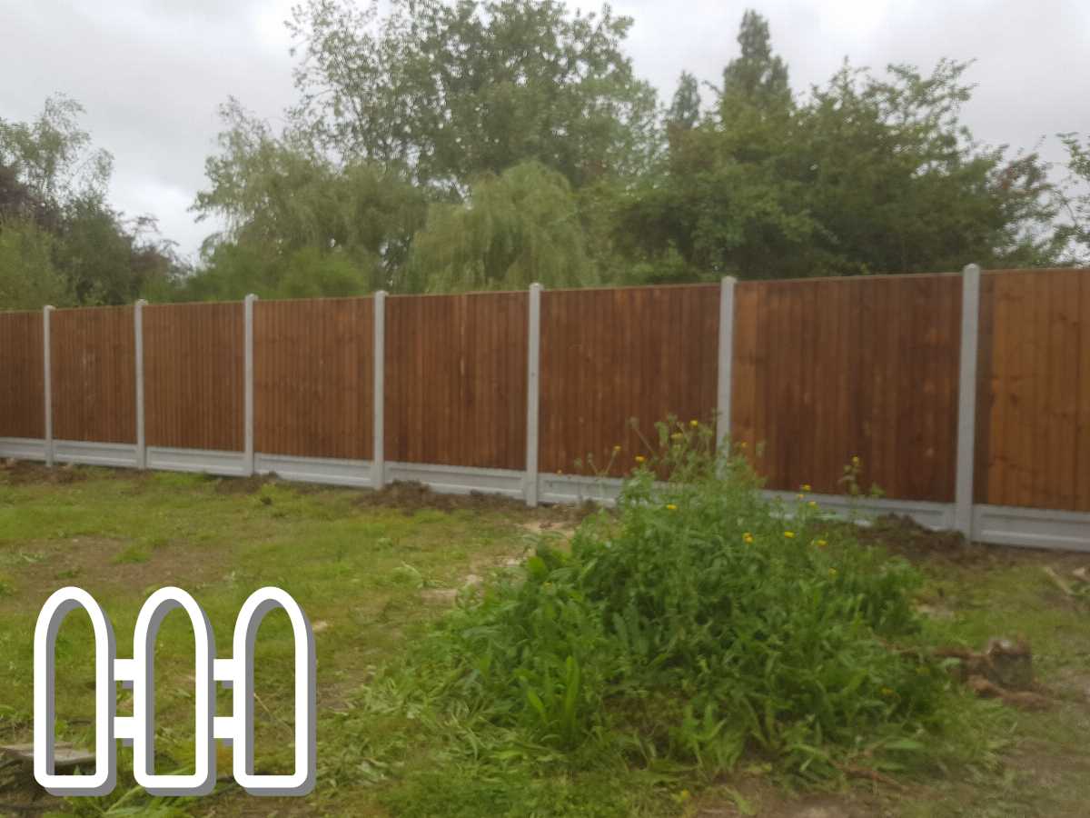 New wooden fence panels installed in a backyard with lush greenery and trees in the background, providing privacy and security to the property.