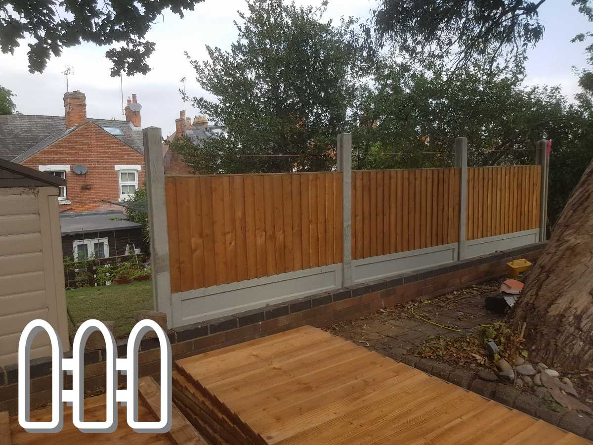 Newly installed wooden fence panels with concrete posts in a residential backyard, showcasing home exterior enhancement