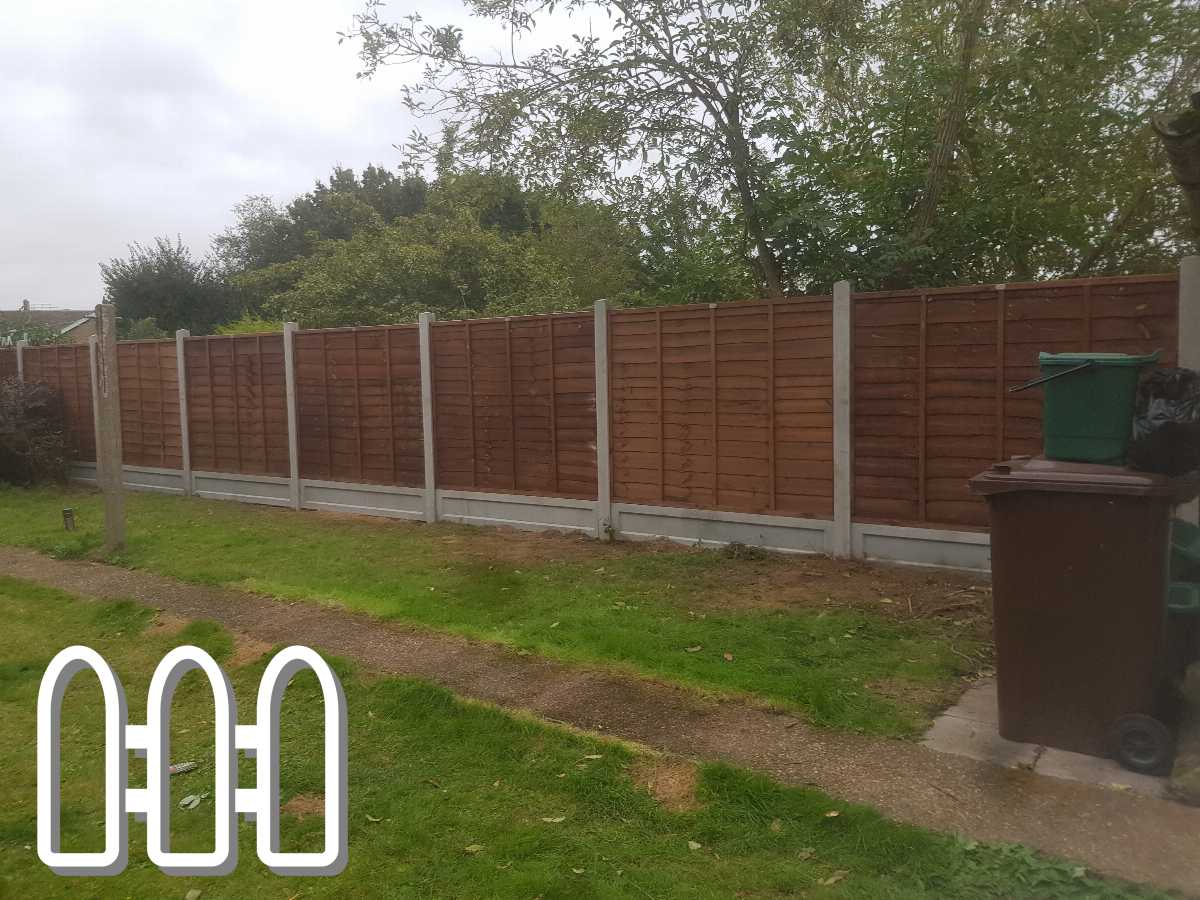 New wooden fence panels mounted on concrete posts with a green and brown waste bin in the foreground and green garden landscape in the background