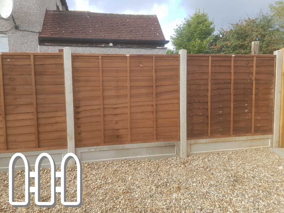 Newly installed wooden panel fence with concrete posts in a residential backyard