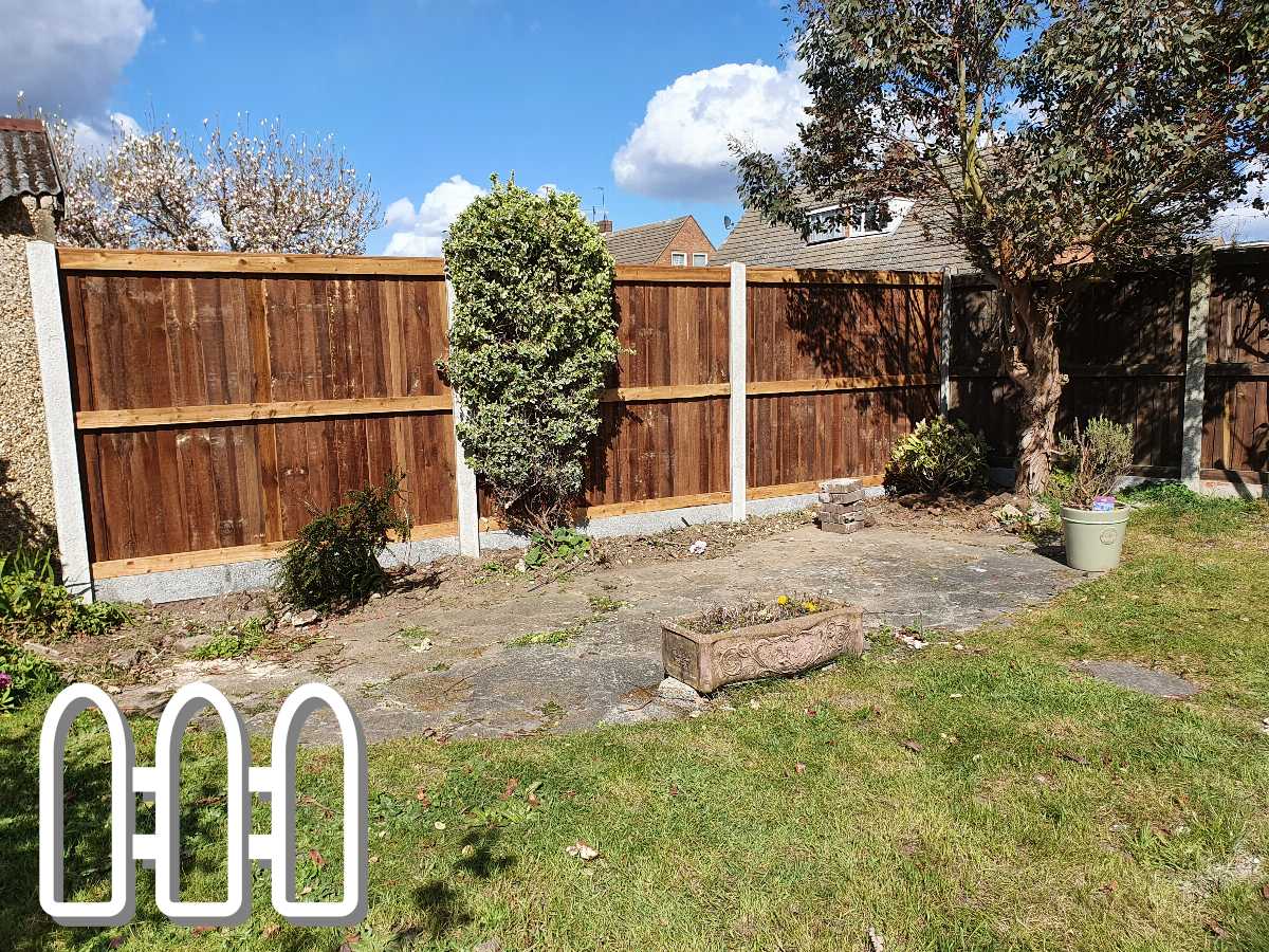 Wooden fence panels installed in a residential garden with a grass lawn, paving stones, and a variety of shrubs.